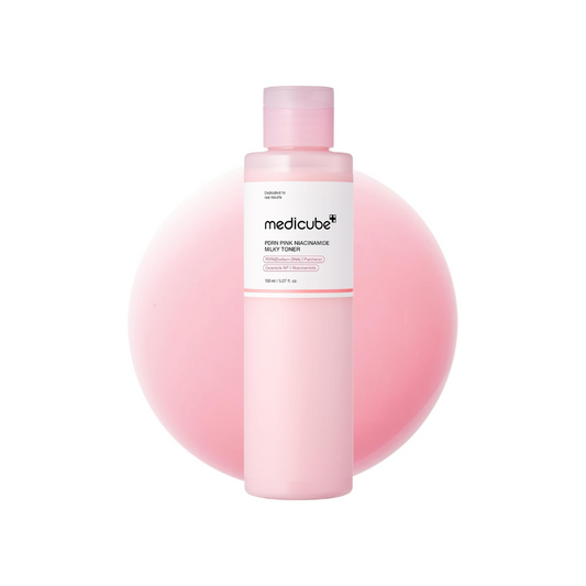 MEDICUBE PDRN Pink Niacinamide Milky Toner is a brightening and nourishing toner designed to even skin tone and boost radiance. Enriched with Niacinamide, PDRN, and Rice Bran Oil, it helps improve skin texture while providing deep hydration. Infused with Centella Asiatica, Jasmine Flower Water, and Ceramides, it soothes, strengthens the skin barrier, and locks in moisture. This non-comedogenic formula is suitable for all skin types, leaving the skin soft, smooth, and glowing.