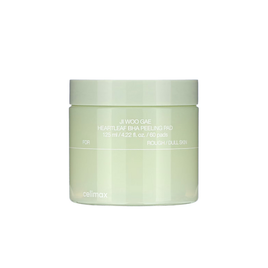 CELIMAX Ji Woo Gae Heartleaf BHA Peeling Pad is a gentle exfoliating pad designed to smooth and clarify the skin. Formulated with Betaine Salicylate (BHA), it helps remove dead skin cells and unclog pores, while Heartleaf Extract, Tea Tree, and Green Tea Water calm and refresh the skin. Enriched with Sodium Hyaluronate and Centella actives, these pads provide hydration and soothing care, leaving skin soft, clear, and balanced with every swipe.