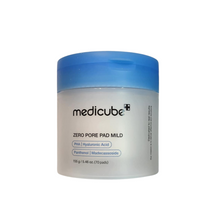 Load image into Gallery viewer, MEDICUBE Zero Pore Pad Mild is designed to gently yet effectively refine pores and improve skin texture. These pre-soaked pads are enriched with a blend of natural extracts such as Pear Fruit, Centella Asiatica, and Rosa Damascena Flower Water, which soothe and hydrate the skin while reducing irritation. The formula includes multiple forms of Hyaluronic Acid, ensuring deep hydration without leaving any greasy residue. Ideal for daily use, these pads help to maintain a clear, smooth complexion by balancing m